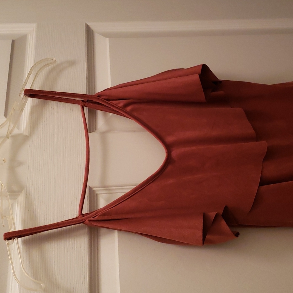 Velvet rust colored bodysuit. New with tags. Ruffle at neckline.